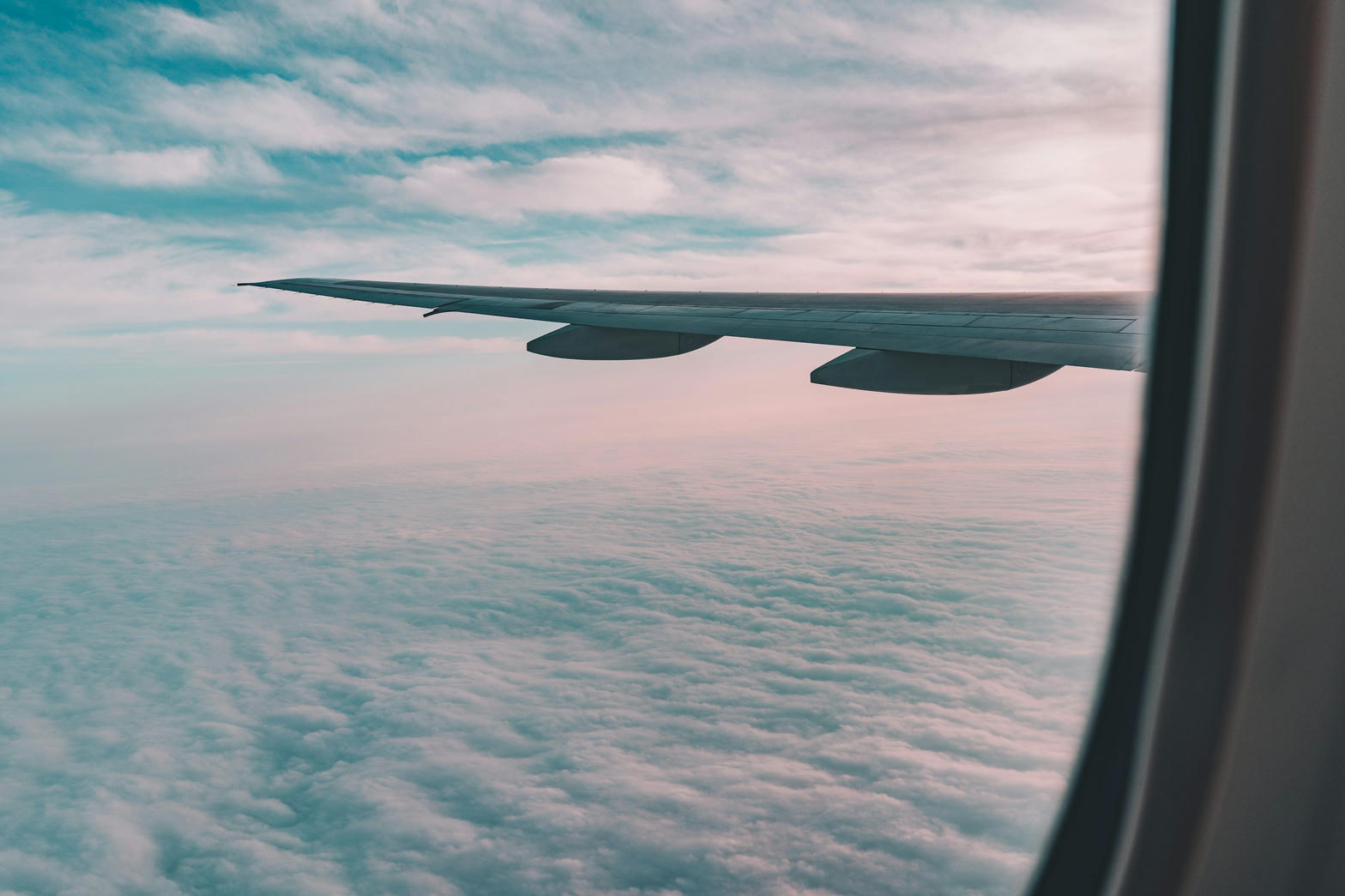 Airplane wing above a sea of clouds