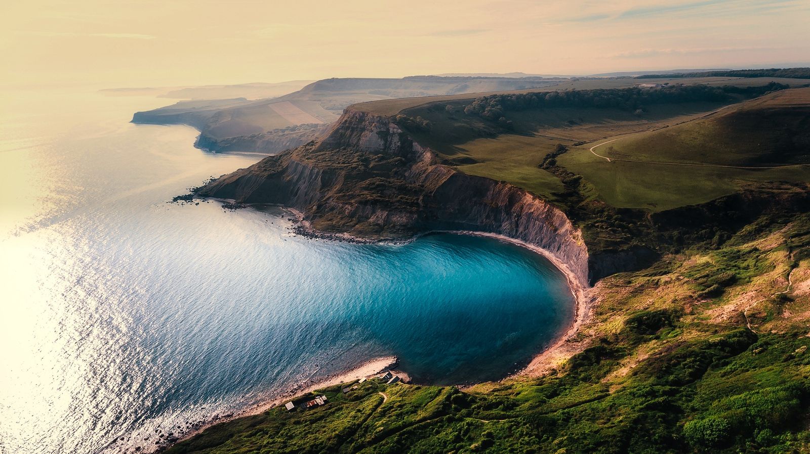 Green coastal cliffs meeting the sea