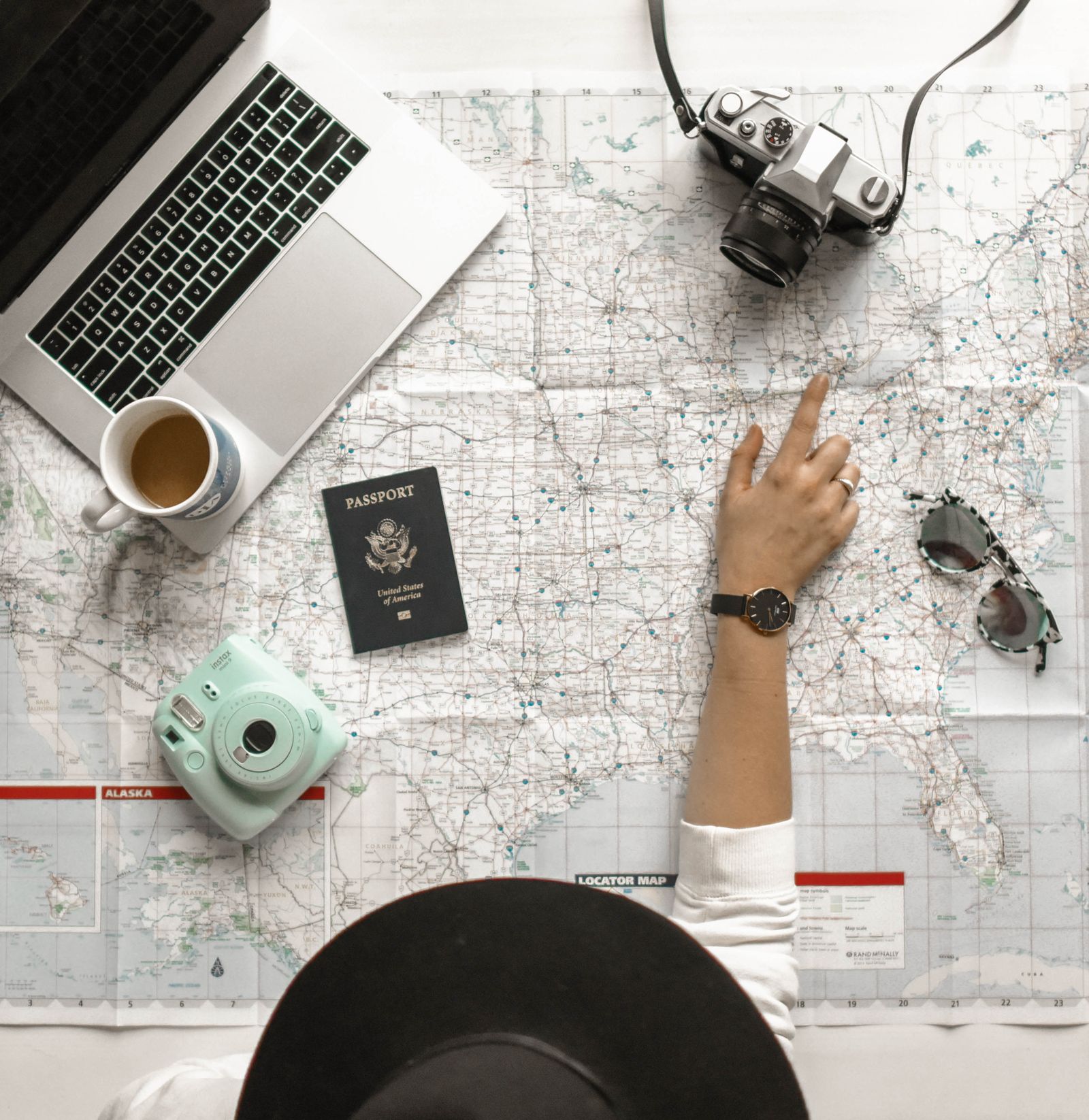 Hands holding a camera above a map