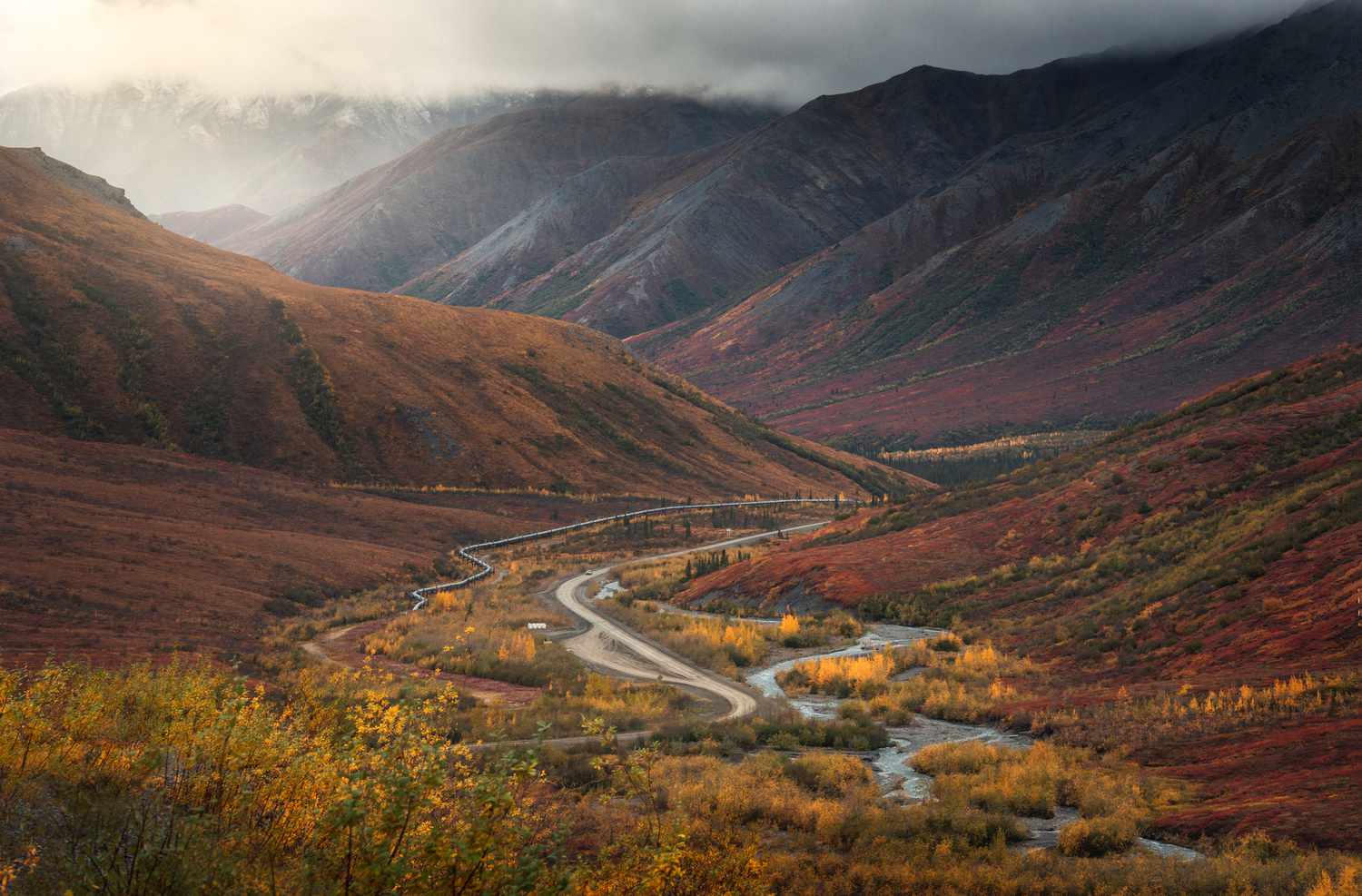 Winding mountain road through autumn hills